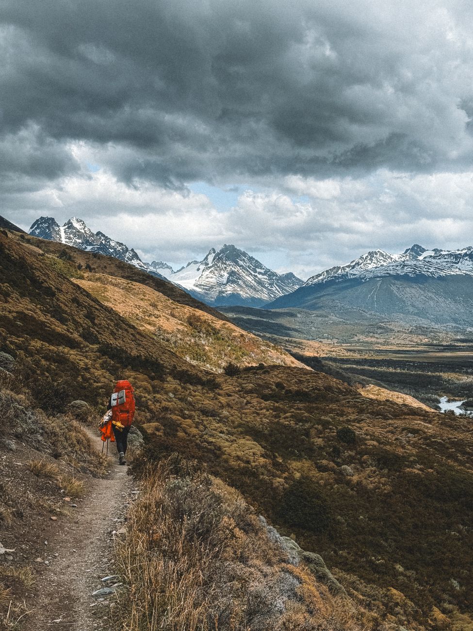 Expansive Patagonian valley with turquoise glacial waters and dramatic granite spires